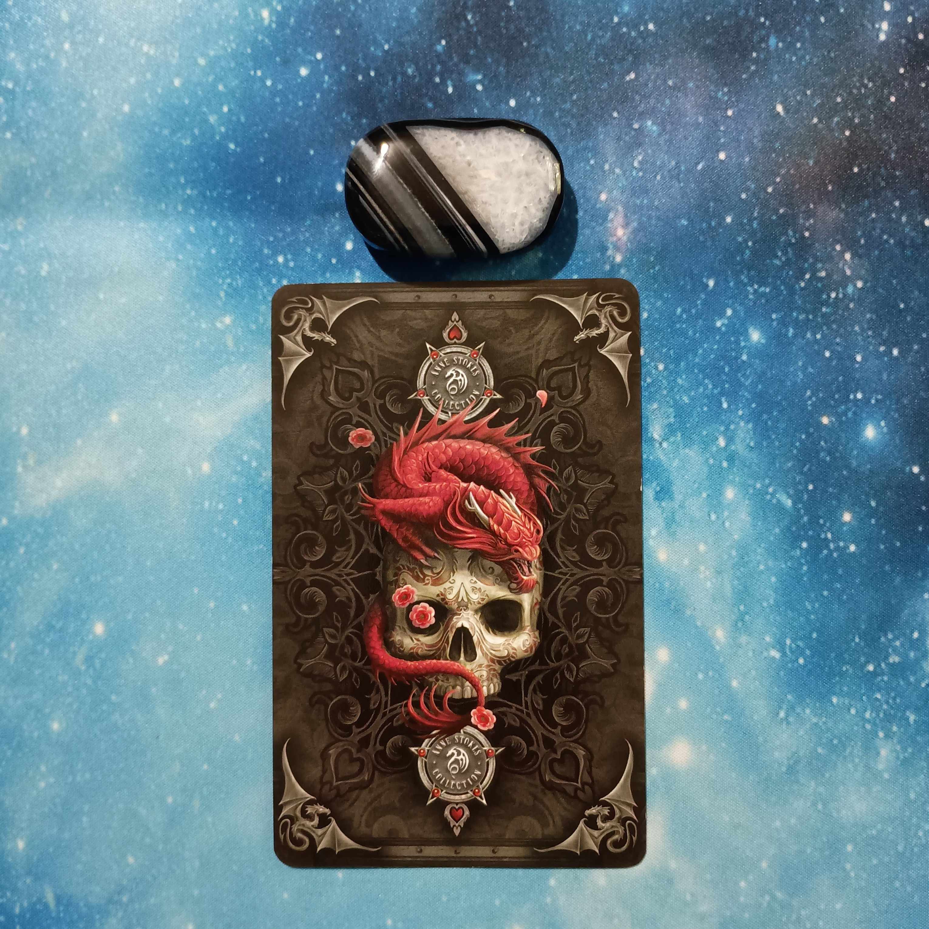 Full Moon Magic: Your August 2025 Pick-a-Card Tarot Reading, Pile 4, Black Agate crystal on a starry blue background, and 1 oracle card, face down