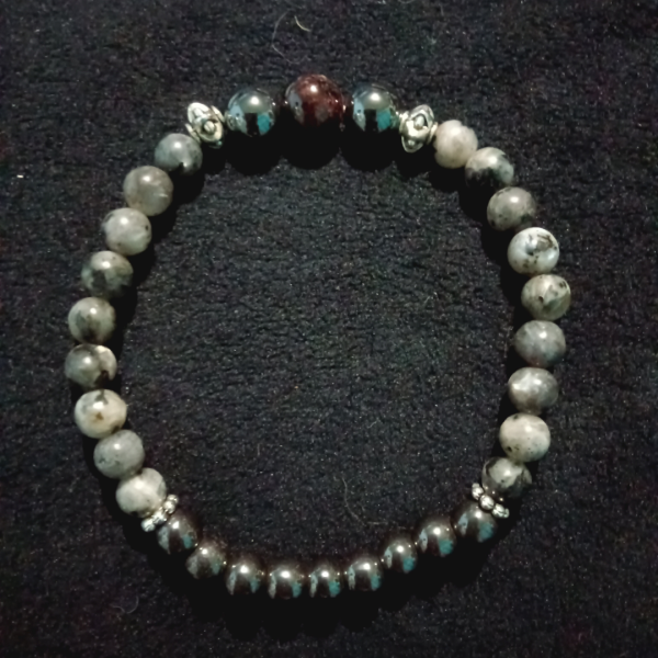 Spiritual Grounding Garnet, Labradorite, and Hematite Bracelet for Connection & Stability, top view, black background
