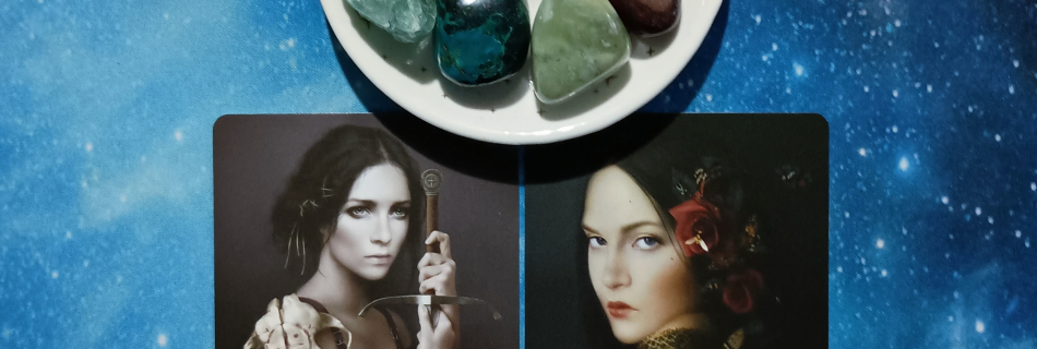 Finding Joy in Hard Times ~ A Message From the Universe, 2 Elle Qui Oracle cards and crystals on a starry blue background