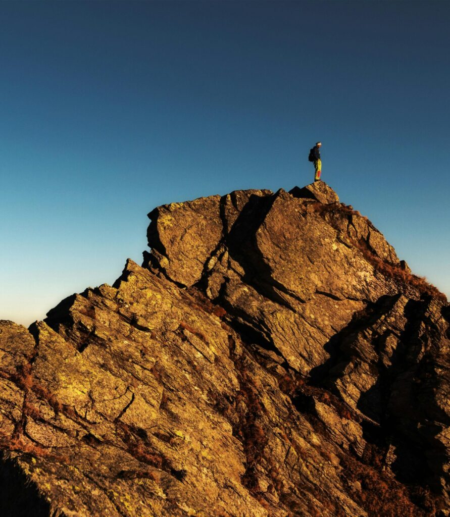 Person on top of a mountain, photo by eberhard grossgasteiger on Pexels,com