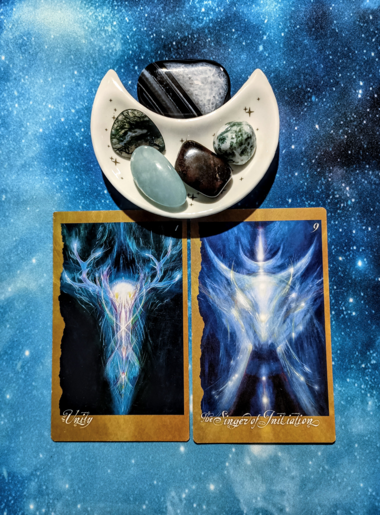 We Are All One: A Message From the Universe, 2 Faeries’ Oracle cards and crystals on a starry blue background