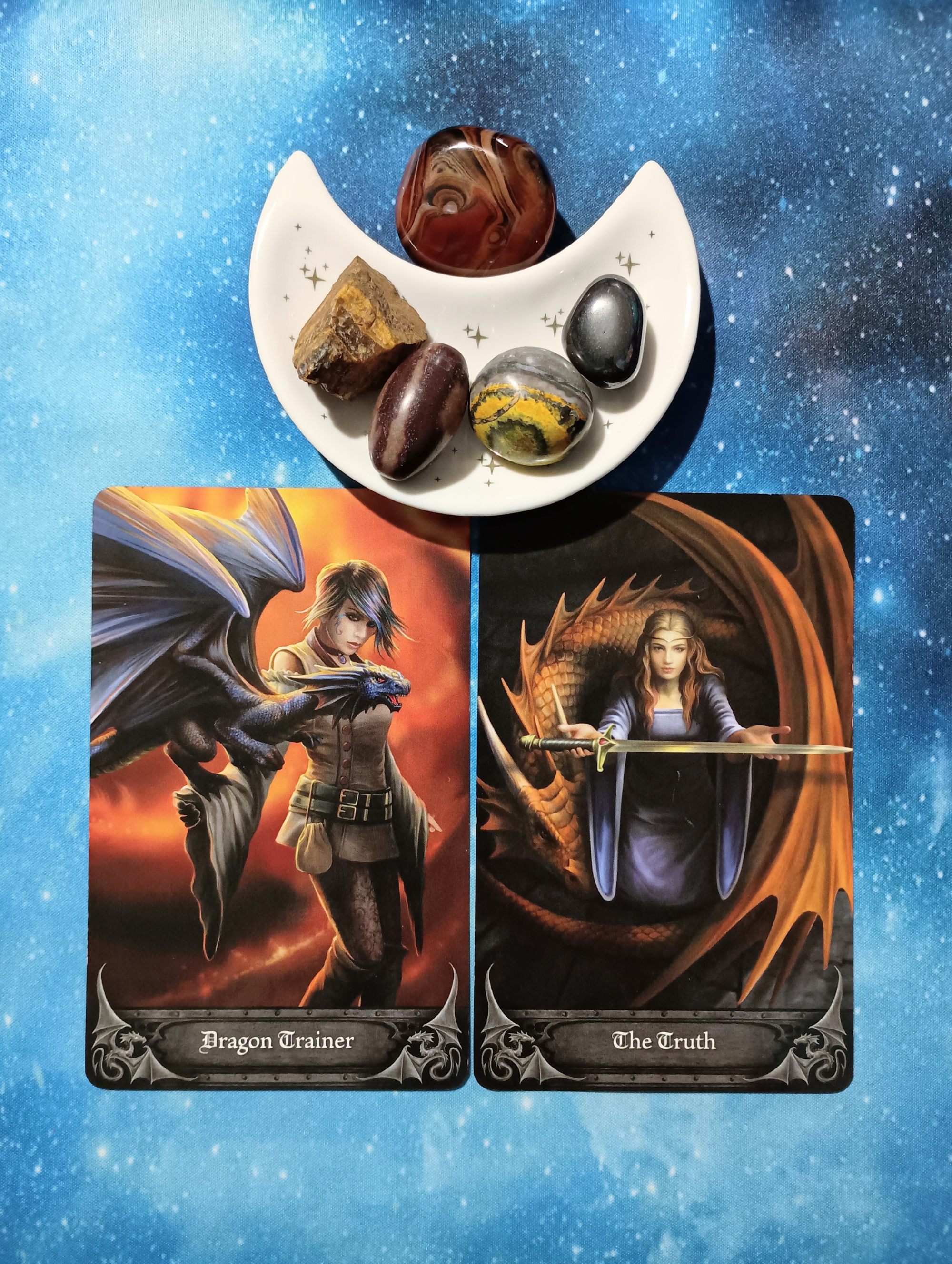 Accepting The Truth: A Message From the Universe, 2 Anne Stokes Gothic Oracle cards and crystals on a starry blue background