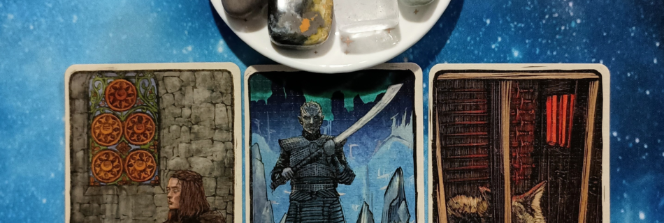 Sunny Skies Ahead! A Message From the Universe, 3 Game of Thrones Tarot cards and crystals on a starry blue background