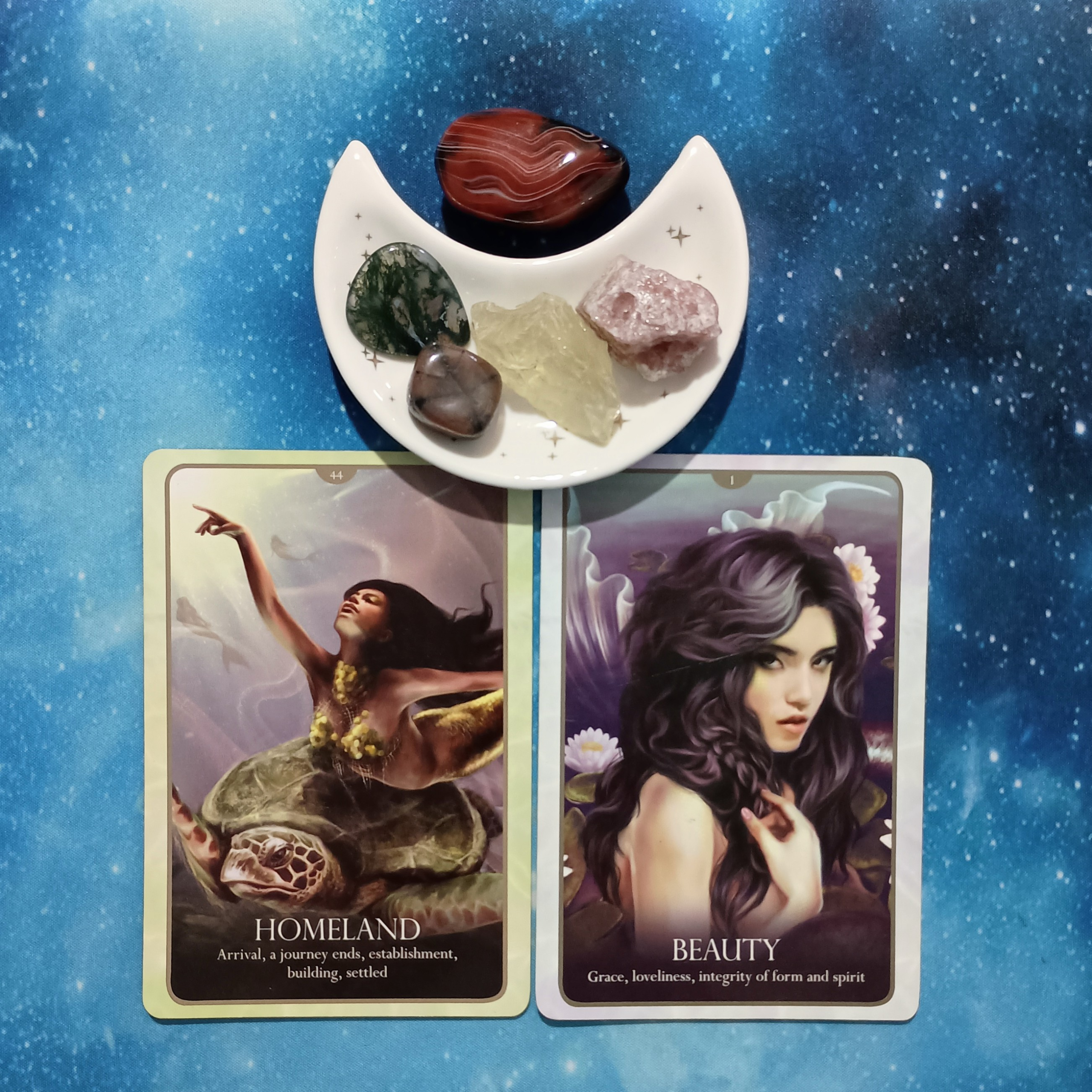 Build from the Heart: A Message From the Universe, 2 Oracle of the Mermaids cards and crystals on a starry blue background